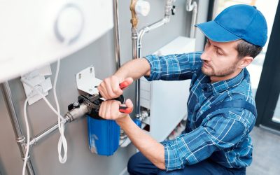 young-man-in-workwear-using-pliers-while-installing-water-filtration-system.jpg